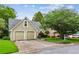 Exterior view of a home with a two-car garage and beautifully landscaped yard at 4710 Vineyard Se Ct, Smyrna, GA 30082