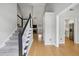 Welcoming foyer featuring hardwood floors, a staircase, and views of the living room and kitchen at 4710 Vineyard Se Ct, Smyrna, GA 30082