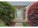 Inviting front entrance with decorative stone accents, a light green door, and colorful landscaping at 4710 Vineyard Se Ct, Smyrna, GA 30082