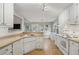 Bright kitchen featuring white cabinets, stainless steel appliances, and view to the backyard at 4710 Vineyard Se Ct, Smyrna, GA 30082