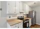 Modern kitchen with white cabinetry, stainless steel appliances, and warm countertops at 4710 Vineyard Se Ct, Smyrna, GA 30082