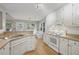 Bright kitchen features white cabinets, stainless sink, and spacious countertops for meal preparation at 4710 Vineyard Se Ct, Smyrna, GA 30082