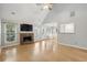 Bright living room featuring a stone fireplace, hardwood floors, and a view into the kitchen at 4710 Vineyard Se Ct, Smyrna, GA 30082