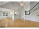 Open-concept living room with hardwood floors, stairs, and view of the kitchen at 4710 Vineyard Se Ct, Smyrna, GA 30082