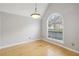 Bright room with large arched window, light hardwood floors, and neutral paint at 4710 Vineyard Se Ct, Smyrna, GA 30082