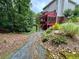 Wooded backyard area with a private back entrance and lush greenery at 703 Overlook Point, Woodstock, GA 30189