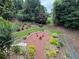 Backyard features a stylish seating area with mature trees, perfect for outdoor entertaining at 703 Overlook Point, Woodstock, GA 30189