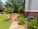 A lush green backyard with mature trees and a cozy seating area with a fire pit at 703 Overlook Point, Woodstock, GA 30189