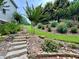 Stone steps lead up the terraced backyard with meticulous landscaping at 703 Overlook Point, Woodstock, GA 30189