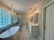 Luxurious bathroom features standalone tub, glass-enclosed shower, and dual sinks at 703 Overlook Point, Woodstock, GA 30189