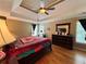 Comfortable bedroom featuring tray ceiling, hardwood floors, bureau and natural light at 703 Overlook Point, Woodstock, GA 30189