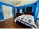 Bright bedroom with a queen bed, wood floors, and walk-in closet at 703 Overlook Point, Woodstock, GA 30189