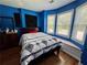 Bright bedroom with a queen bed, wood floors, and a bay window at 703 Overlook Point, Woodstock, GA 30189