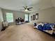 Spacious carpeted bedroom with a bed, desk, and a ceiling fan at 703 Overlook Point, Woodstock, GA 30189