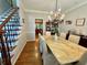 Dining room with wood floors, chandelier, and marble table at 703 Overlook Point, Woodstock, GA 30189