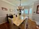 Dining room with chandelier, wood floors, and shuttered windows at 703 Overlook Point, Woodstock, GA 30189