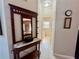 Inviting hallway features decorative mirror table, tiled floors, and convenient access to a half bathroom at 703 Overlook Point, Woodstock, GA 30189