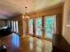 Bright living room with hardwood floors, chandelier, and scenic backyard views at 703 Overlook Point, Woodstock, GA 30189