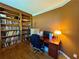 Cozy office space with a built-in bookcase, desk, and natural light at 703 Overlook Point, Woodstock, GA 30189