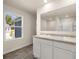 Bathroom featuring a double vanity with white cabinets and tile flooring at 8225 Coldstream Dr, Fairburn, GA 30213
