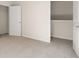 Neutral-toned bedroom with carpet, a closet, and an open doorway to another room at 8225 Coldstream Dr, Fairburn, GA 30213