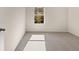 Neutral-toned bedroom with gray carpet with a window letting in bright natural light at 8225 Coldstream Dr, Fairburn, GA 30213