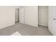 A neutral-toned bedroom with carpet, a closet, and an open doorway to another room at 8225 Coldstream Dr, Fairburn, GA 30213