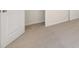 Neutral-toned bedroom with carpet, and doorways to a closet and open doorway to another room at 8225 Coldstream Dr, Fairburn, GA 30213