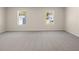 Spacious bedroom with neutral carpet, two windows, and ample natural light at 8225 Coldstream Dr, Fairburn, GA 30213