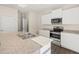 Kitchen with an island, granite countertops, stainless steel appliances and white cabinets at 8225 Coldstream Dr, Fairburn, GA 30213