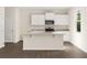 Kitchen with an island, granite countertops and stainless steel appliances at 8225 Coldstream Dr, Fairburn, GA 30213