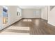 Bright living room with hardwood floors and large windows letting in natural light at 8225 Coldstream Dr, Fairburn, GA 30213