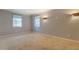 Comfortable bedroom with neutral carpet, natural light, and stylish wall lighting at 115 Plantation Dr, Clarkston, GA 30021