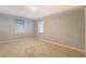 Bedroom with neutral carpet, paint, and window with black and white curtains at 115 Plantation Dr, Clarkston, GA 30021
