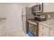 Modern kitchen featuring stainless steel appliances, tile flooring and granite countertops at 115 Plantation Dr, Clarkston, GA 30021