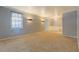 Bright living room featuring neutral carpet, large windows, and ample space at 115 Plantation Dr, Clarkston, GA 30021