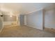 Open-concept living room with a view to the dining area and kitchen featuring neutral carpet at 115 Plantation Dr, Clarkston, GA 30021