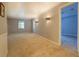Comfortable living space with neutral carpet, sconce lighting, and plenty of natural light at 115 Plantation Dr, Clarkston, GA 30021