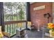 Cozy balcony with brick wall, outdoor seating, and serene view of trees at 1286 Creekside Se Ter, Smyrna, GA 30082