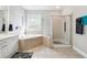 Bathroom showcasing corner tub, large window, and glass door shower at 1286 Creekside Se Ter, Smyrna, GA 30082