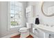 Cozy bathroom with single sink, commode, and storage shelves at 1286 Creekside Se Ter, Smyrna, GA 30082