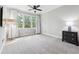 Bright bedroom features neutral walls, carpet, ceiling fan, and an abundance of natural light from the large window at 1286 Creekside Se Ter, Smyrna, GA 30082