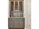 Charming butler's pantry with glass-front cabinets and granite countertops at 1286 Creekside Se Ter, Smyrna, GA 30082