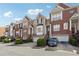 A row of townhomes featuring brick exteriors, garages, front steps, and tidy landscaping at 1286 Creekside Se Ter, Smyrna, GA 30082