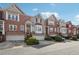 Exterior shot of the townhomes shows the brick facade, driveways, and front gardens at 1286 Creekside Se Ter, Smyrna, GA 30082