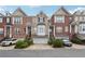 Exterior of the townhomes showcases a traditional brick facade, attached garages, and well-maintained landscaping at 1286 Creekside Se Ter, Smyrna, GA 30082