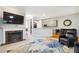 Open-concept living room featuring a fireplace, hardwood floors, and a view of the kitchen at 1286 Creekside Se Ter, Smyrna, GA 30082