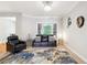 Cozy living room featuring modern decor, a black leather couch, and large window providing natural light at 1286 Creekside Se Ter, Smyrna, GA 30082