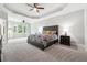 Spacious main bedroom with tray ceilings, neutral carpet, and large windows at 1286 Creekside Se Ter, Smyrna, GA 30082