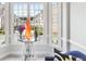 Close-up of sitting area with vases and a table in front of large windows with neighborhood view at 1286 Creekside Se Ter, Smyrna, GA 30082